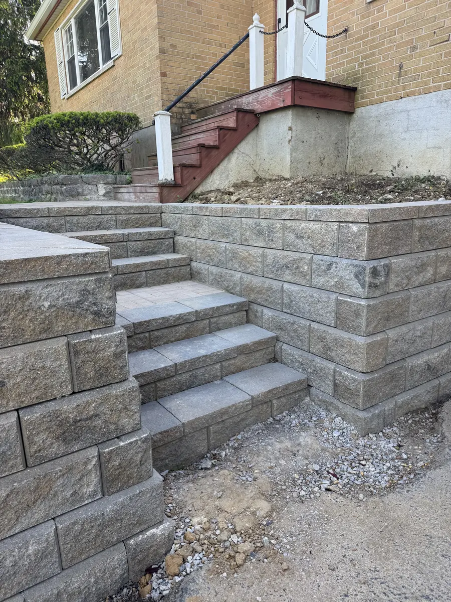 Paver steps and landing built at a tan brick home