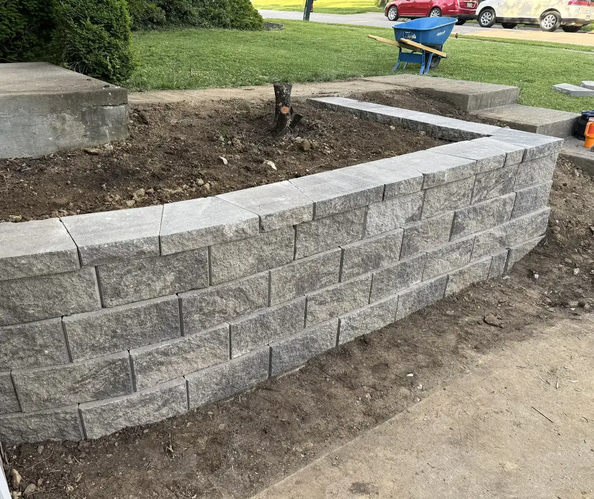 Curved block seating wall with cap stones at a front entry